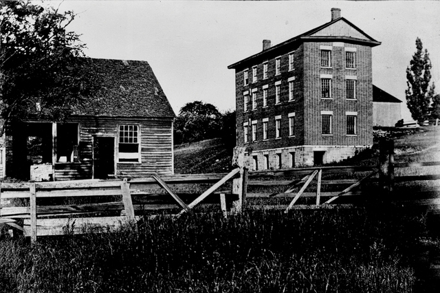 Vintage photograph of Blacksmith Shop and Woolen Mill. 1896